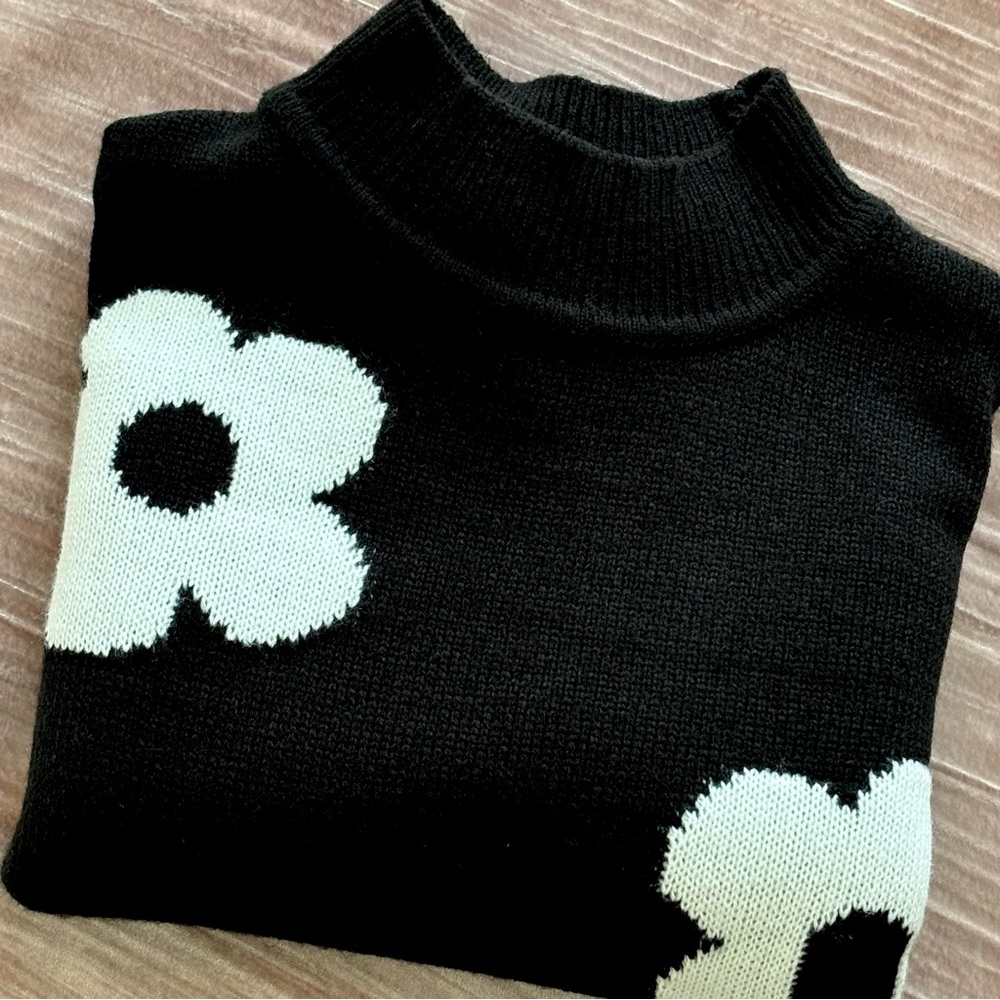 H&M cropped, black turtleneck sweater with white flowers.